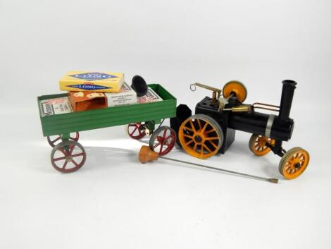 A Mamod live steam traction engine and trailer.