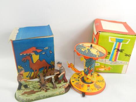 Two tin plate toy carousel rides