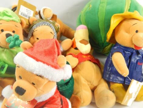 A collection of modern Winnie the Pooh soft toys