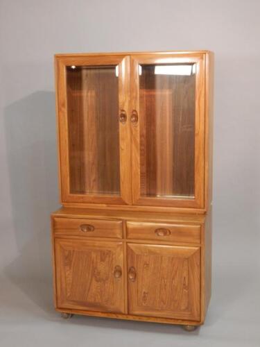 An Ercol light elm retro style display cabinet