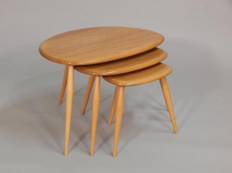 A nest of three Ercol retro light elm tables