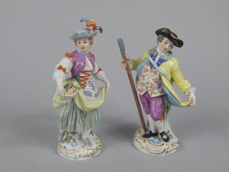 A near pair of Meissen style figures