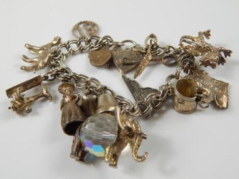 A silver charm bracelet and various silver and silver plated charms