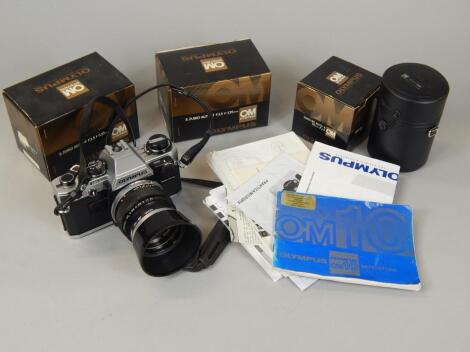 An Olympus OM10 camera with lens and some accessories