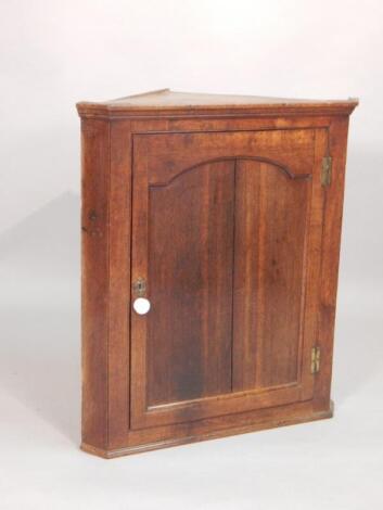 A late 18thC oak hanging corner cupboard