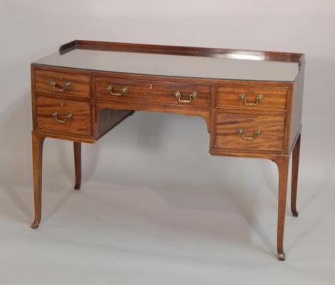 A bow fronted mahogany dressing table in George III style