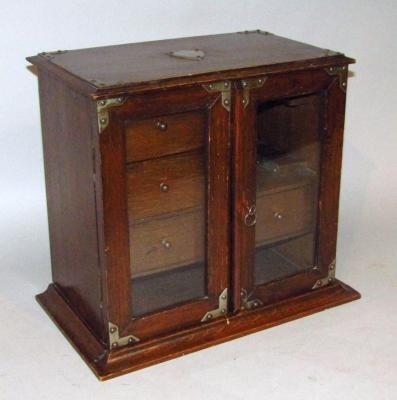 An early 20thC oak smoker's cabinet