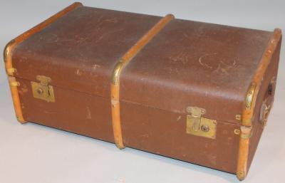 An early 20thC pressed leather and wooden bound travel trunk