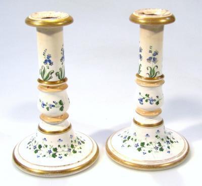 A pair of semi porcelain candlesticks