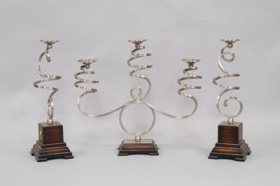 A contemporary metal three branch candelabra