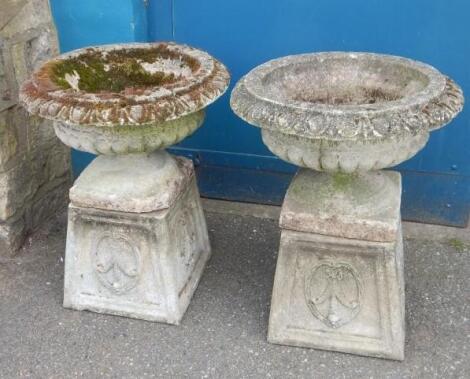 A pair of composition of garden urns