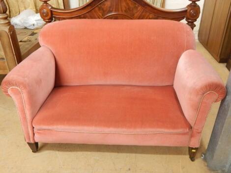 An Edwardian drop arm sofa