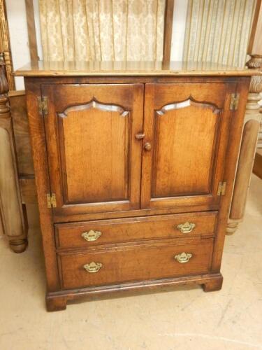 A reproduction oak TV cabinet in Titchmarsh and Goodwin style