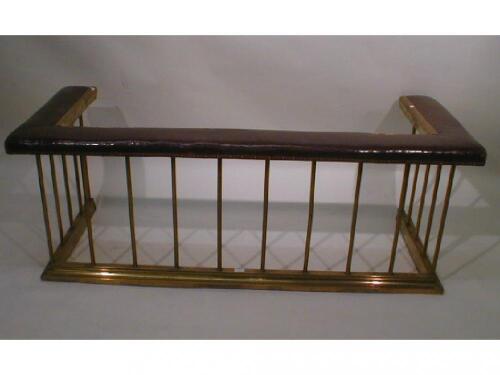 A brass club fender, with leather cushion top rail, 63" wide