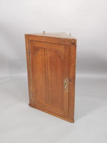 An early 19thC oak corner cabinet