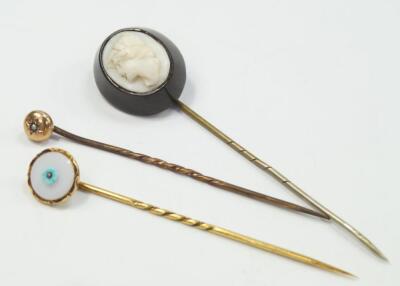 Three stone set stick pins.