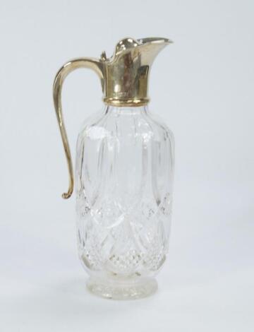 A cut crystal claret jug
