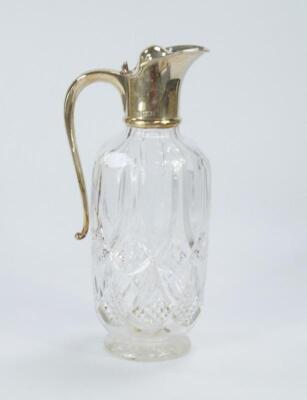 A cut crystal claret jug