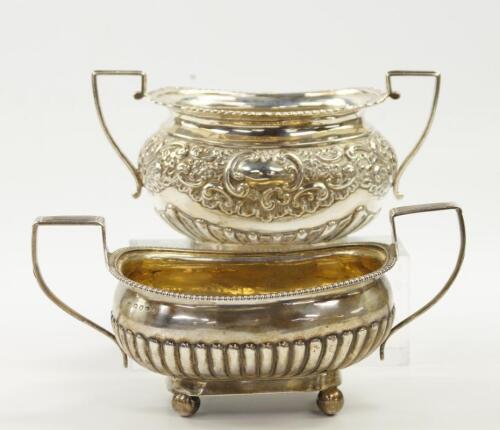 A George III silver twin handled semi-fluted sugar bowl