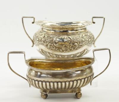 A George III silver twin handled semi-fluted sugar bowl