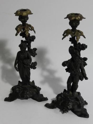 A pair of 19thC cast two colour metal figural candlesticks