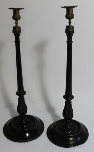 A pair of early 20thC mahogany candlesticks