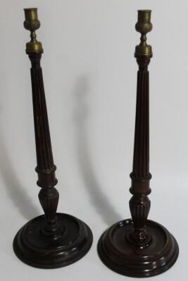 A pair of early 20thC mahogany candlesticks