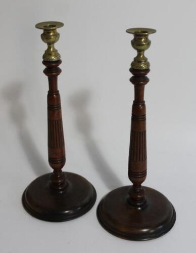 A pair of early 20thC oak candlesticks