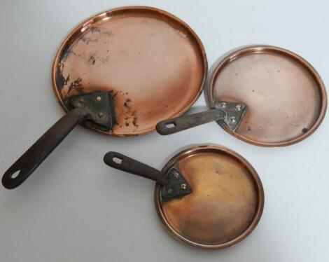 A graduated set of three Victorian copper saucepan covers