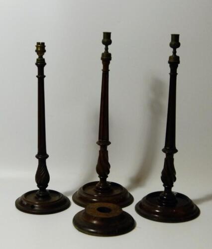 A pair of mahogany candlesticks