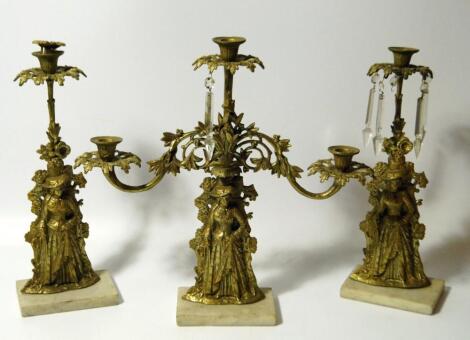 A Victorian garniture of gilt brass candlesticks