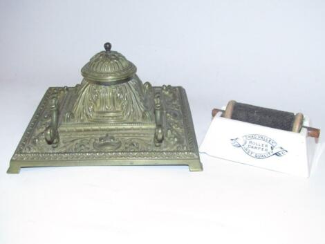 A cast brass desk inkwell