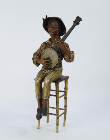 A late 19thC/early 20thC cold painted figure of a young banjo player