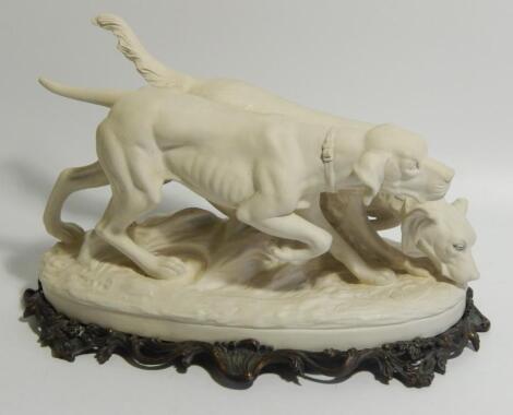 A Weldon Pottery bisque figure group of a pointer and a setter