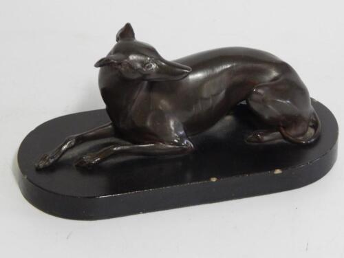 An early 20thC Spelter model of a recumbent greyhound