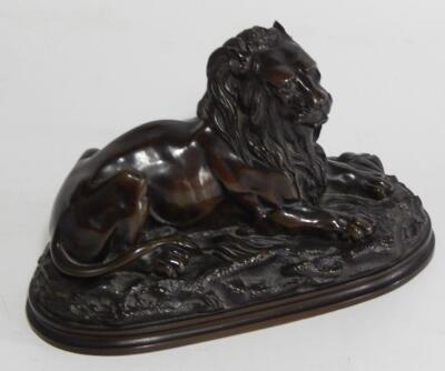 A late 19thC bronze model of a recumbent male lion
