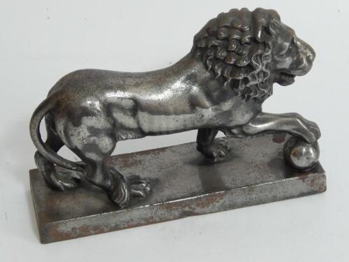 A cast iron model of a male lion