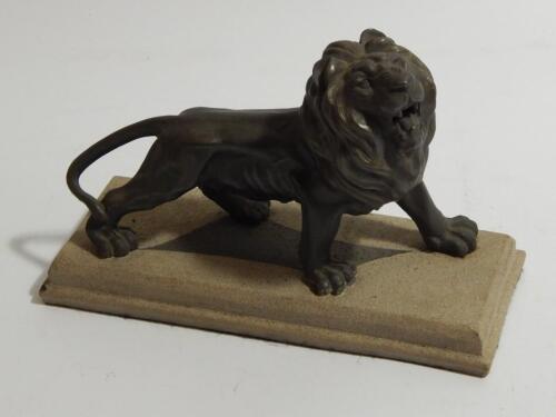A spelter model of a standing male lion