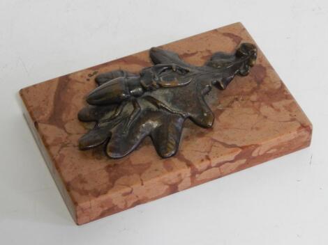 An early 20thC bronze model of a stag beetle on an oak leaf