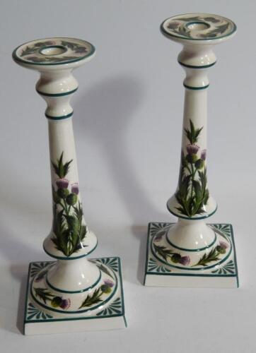 A pair of 20thC Griselda Hill pottery Wemyss style candlesticks