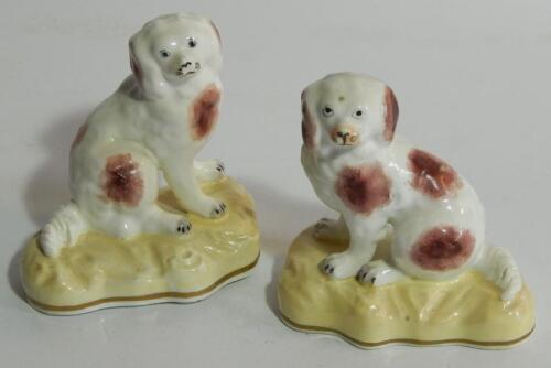 A pair of 19thC Staffordshire porcelain figures of spaniels