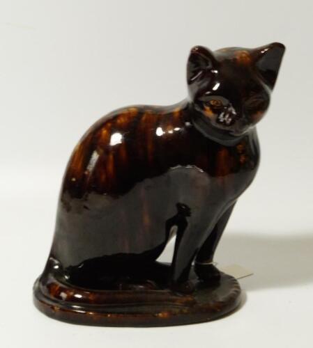 A 19thC treacle glazed pottery figure