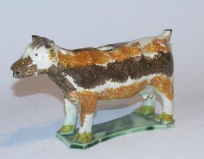 An early 19thC Staffordshire Prattware cow creamer