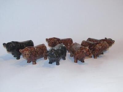 Seven various treacle glazed pottery figures of Highland and Aberdeen Angus calves