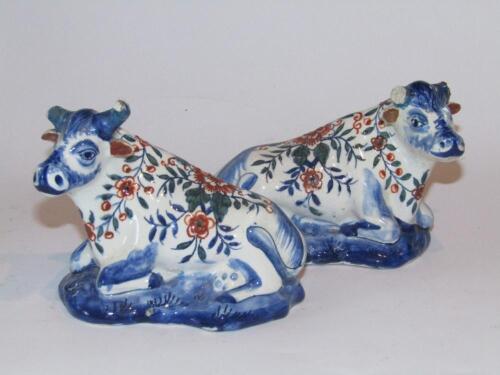 A pair of Dutch Delft tin glazed earthenware figures of cattle