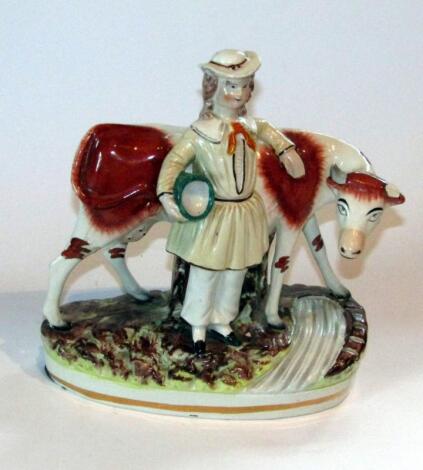 A late 19thC Staffordshire milkmaid and cow group