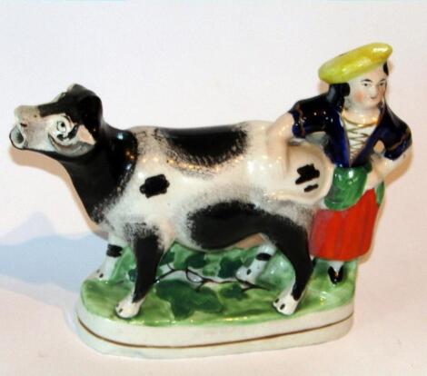 A mid-19thC Staffordshire maid and cow figure group