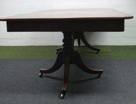 An early 19thC twin pedestal mahogany concertina action twin pedestal dining table