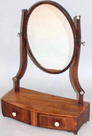 A George III mahogany bow front table mirror