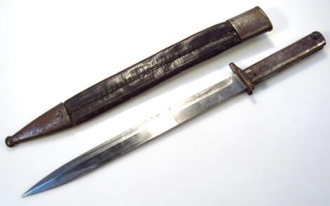 An early 20thC bayonet and leather scabbard